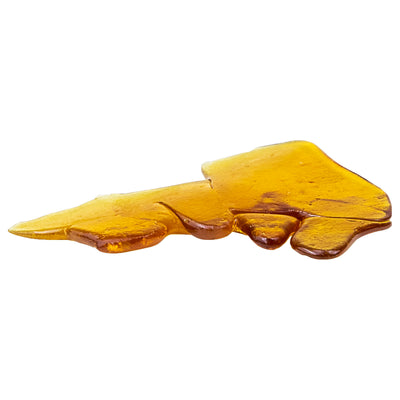 A curled, glossy piece of amber shatter concentrate with a smooth, wavy surface, on a white background.