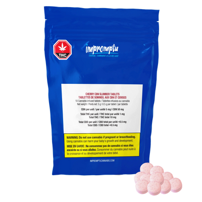 Blue Impromptu Cherry CBN Slumber Tablets pouch beside a pile of pink cannabis-infused tablets.