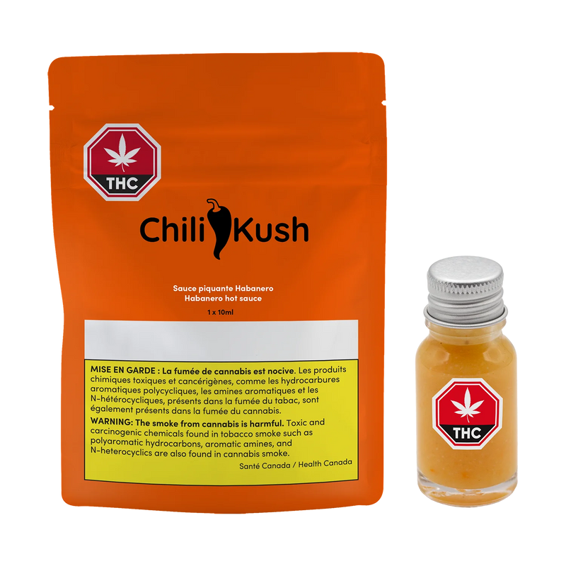 Orange Chili Kush packaging pouch for habanero hot sauce beside a small glass bottle of the orange sauce with a metal cap.