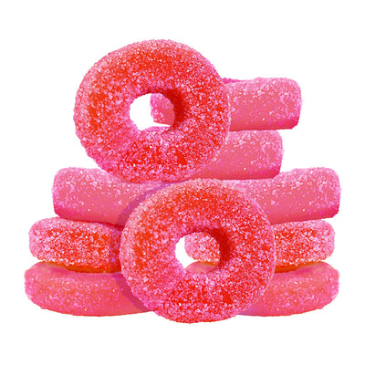 Stacked pile of sugar-coated pink and red sour watermelon gummy rings.