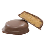 Two chocolate-coated peanut butter bites, one cut open to show the peanut butter filling inside.