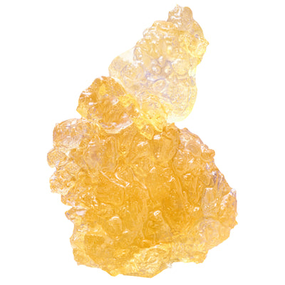 Close-up of a translucent amber cannabis concentrate chunk with a glassy, textured surface.