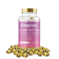 Pink Emprise Canada bottle labeled THC:CBD Softgels (100 count) surrounded by loose amber softgel capsules.