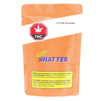 Orange mylar packaging bag labeled RAD Shatter, with '1g Galactic Giggles x Mango Kush Shatter' text, THC symbol, and cannabis warning label.
