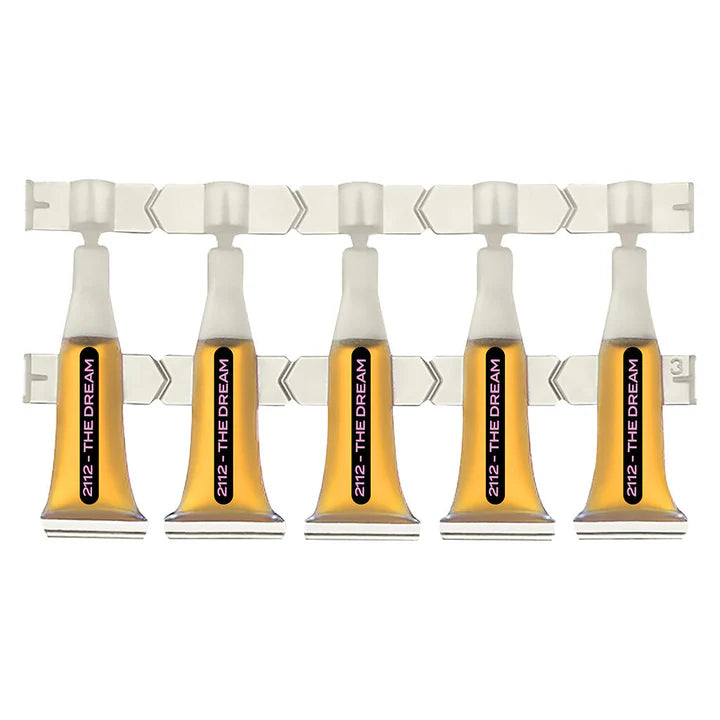 Strip of five 2112 - The Dream single-serve ampules filled with amber liquid, joined on a plastic sheet.