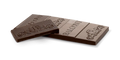 Two broken pieces of the 65% Dark Chocolate CBD Cannatonic Bar, showing the embossed Balcony logo and scroll pattern on the chocolate.