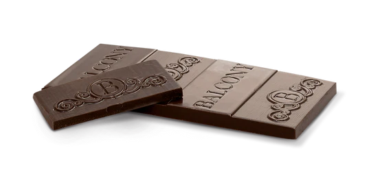 Two broken pieces of the 65% Dark Chocolate CBD Cannatonic Bar, showing the embossed Balcony logo and scroll pattern on the chocolate.