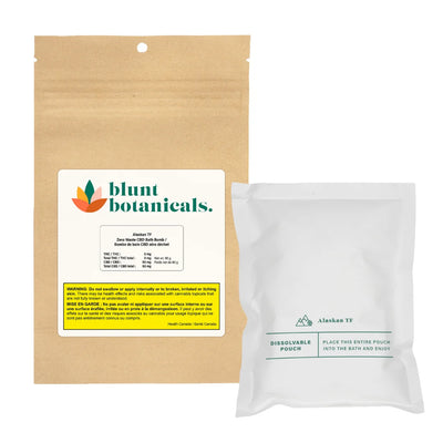 Kraft paper package for Blunt Botanicals Alaskan TF Zero Waste CBD Bath Bomb beside its white dissolvable inner pouch.