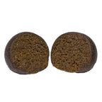 Two round balls of Animal Face Temple Ball hash sliced open, showing a dense, crumbly dark brown interior.