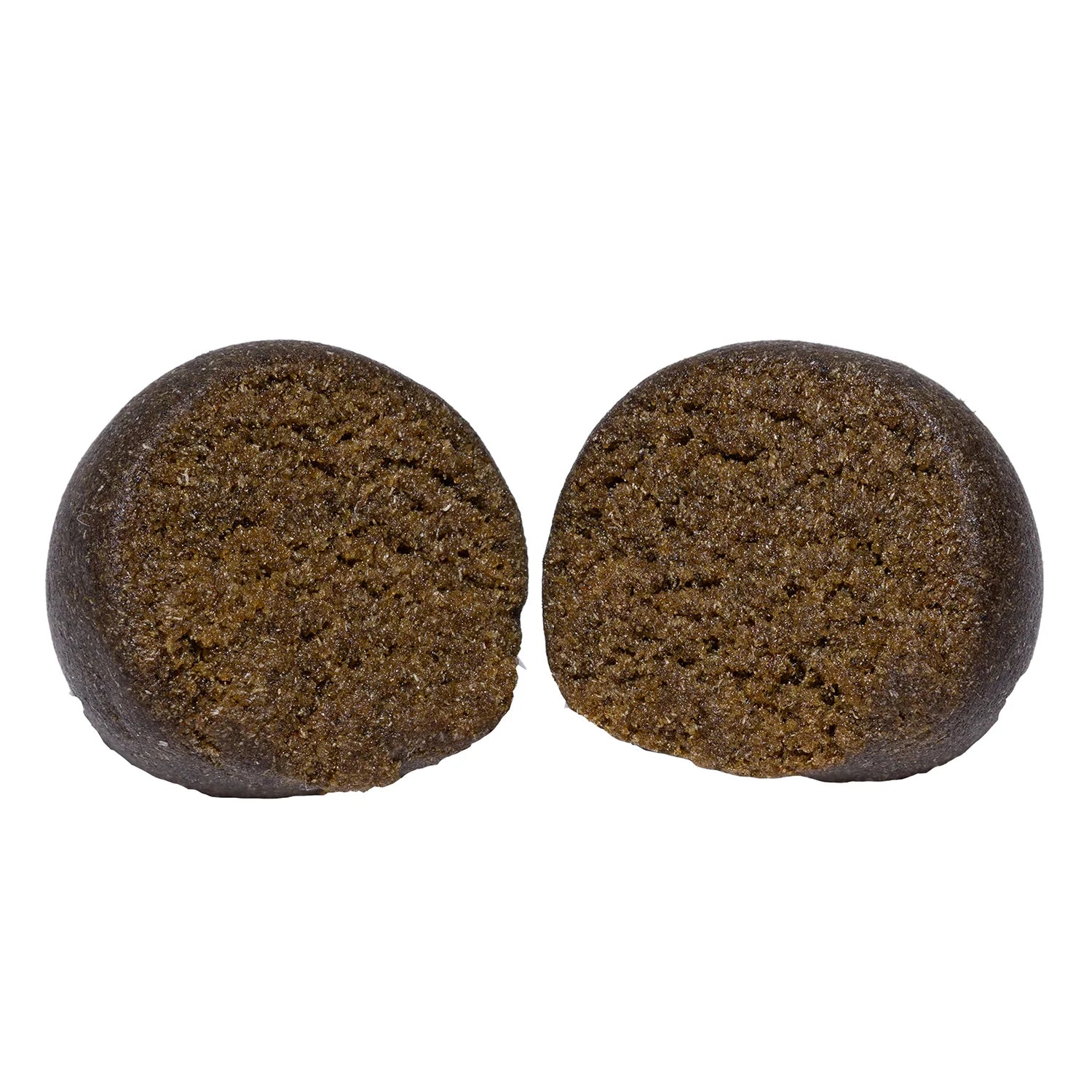 Two round balls of Animal Face Temple Ball hash sliced open, showing a dense, crumbly dark brown interior.