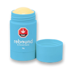 Open blue tube of balm with the cap removed, showing pale yellow product and rebound by Stewart Farms branding.