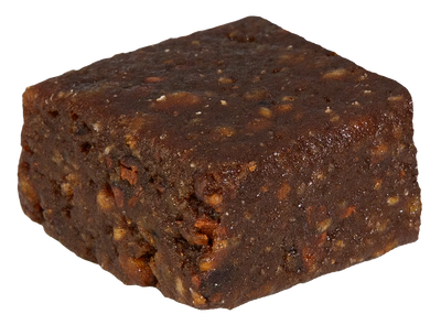 Close-up of a single dark chocolate-coated fruit bite square with a textured, fudge-like surface.