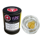Black cylindrical container labeled Fume by Dom Jackson, Bane Chamber Sugar Wax 1g, beside an open jar of golden sugar wax concentrate.