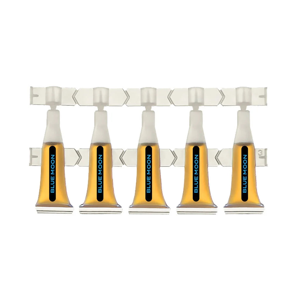 Row of five amber Blue Moon liquid ampules with twist-off tips, connected on a plastic strip.