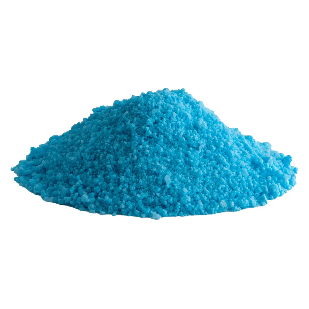 Close-up of loose teal blue bath salt crystals from the Blueberry Sunset CBD Salt Soak.