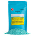 Teal pouch of Blueberry Sunset CBD Salt Soak by rebound Stewart Farms, with a pile of teal bath salt crystals in front.