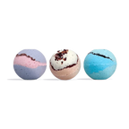 Three round bath bombs in a row: purple and pink swirl, cream with dark red flecks, and blue and teal swirl