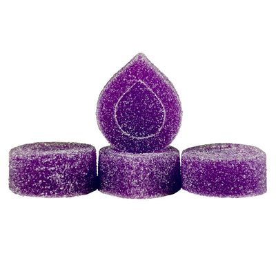 Four sugar-coated purple gummies, one teardrop-shaped and three round, arranged in a small group.