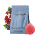 Blue stand-up pouch labeled Kinloch Wellness CBZ CBN + CBD Pomegranate Berry Gummy Drop 15 pack, beside a halved pomegranate, blackberries, and a red sugar-coated gummy.
