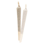 Two cone-shaped pre-rolled joints standing upright, one wrapped in tan paper and one in white paper.