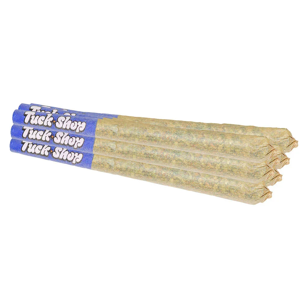 Bundle of four pre-rolled joints with blue Tuck Shop branded paper tips laid side by side.