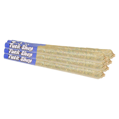 Bundle of four pre-rolled joints with blue Tuck Shop branded paper tips laid side by side.