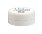Close-up of the round white tin for Intense Hydrating Lip Balm, showing the Blunt Botanicals logo and THC/CBD content printed on the lid.