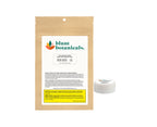 Kraft paper pouch printed with the Blunt Botanicals logo and Intense Hydrating Lip Balm label, next to the small white lip balm tin it contains.