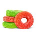 Sugar-coated red and green ring-shaped gummies stacked together on a black background.