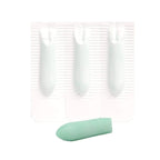 Close-up of three foil-backed suppositories on a blister strip next to one pale green suppository removed from its wrapper.