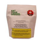 White stand-up pouch for Eat Your Greens Peaches & Cream CBD100 Soft Chews, labeled THC-free, vegan and gluten-free, with a THC symbol and warning text.