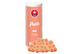 Peach-colored cylindrical container of Pearls by Gron Peach Mango CBD gummies standing beside a pile of the sugar-coated gummies.