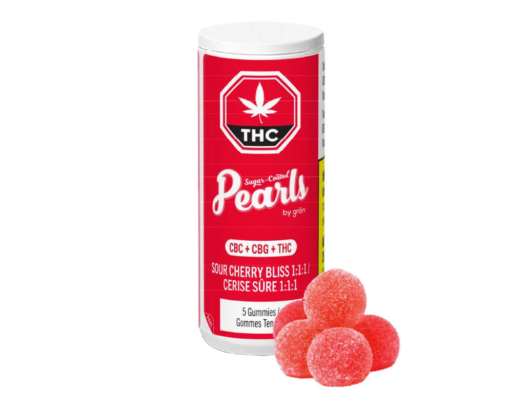 Red tube packaging for Pearls by Gron Sour Cherry Bliss 1:1:1 CBC/CBG/THC gummies beside a small pile of the red gummies.