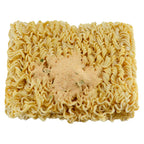 Block of dried ramen-style noodles topped with a mound of seasoning powder, viewed from above.
