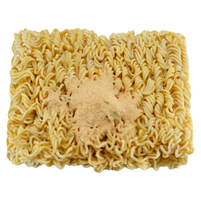 Block of dried ramen-style noodles topped with a mound of seasoning powder, viewed from above.