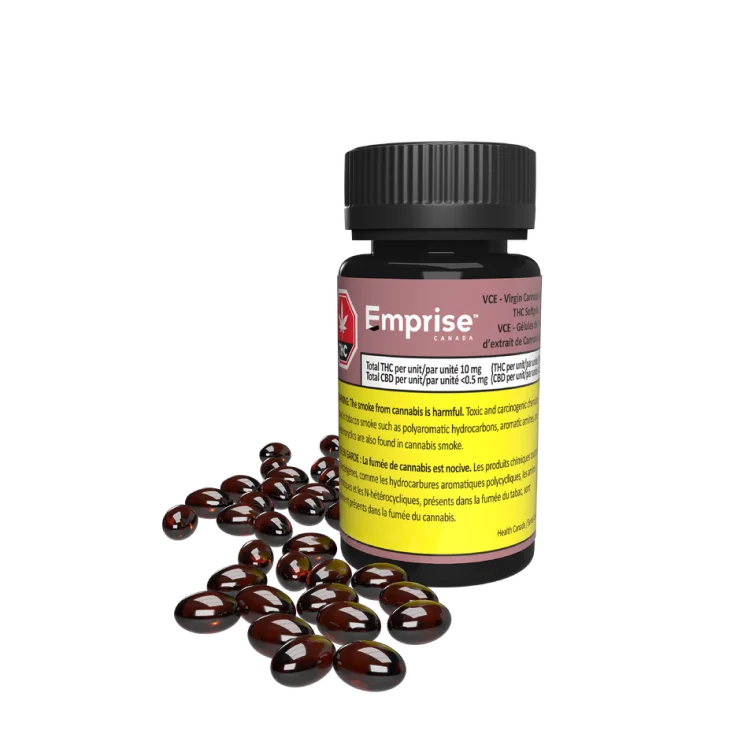 Amber glass bottle labeled Emprise VCE Virgin Cannabis Extract THC Softgels beside a pile of dark red softgel capsules.