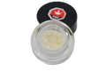 Open glass jar of pale yellow micronized THC isolate powder with its black THC-labeled lid resting beside it