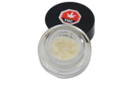 Open glass jar of pale yellow micronized THC isolate powder with its black THC-labeled lid resting beside it