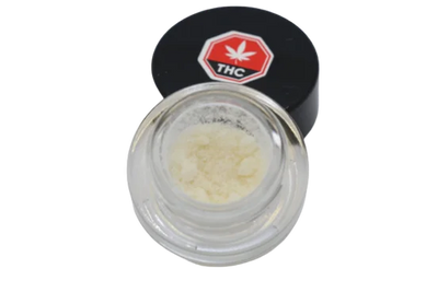 Open glass jar of pale yellow micronized THC isolate powder with its black THC-labeled lid resting beside it