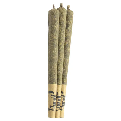 Three tan-papered pre-rolled joints branded Carmel standing upright side by side.